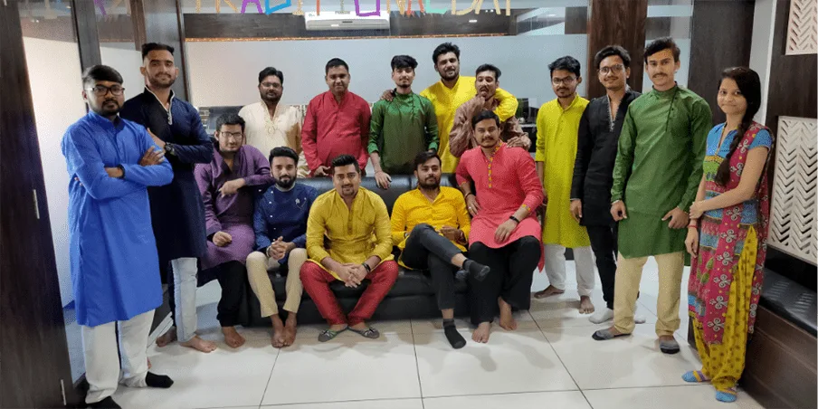The Groovy Web team posing together in traditional outfits on Traditional Day