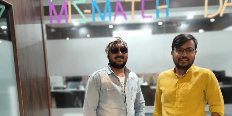 Two teammates in mismatched outfits on Mis-Match Day